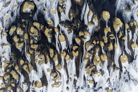 Snow covered lava beach from the sky